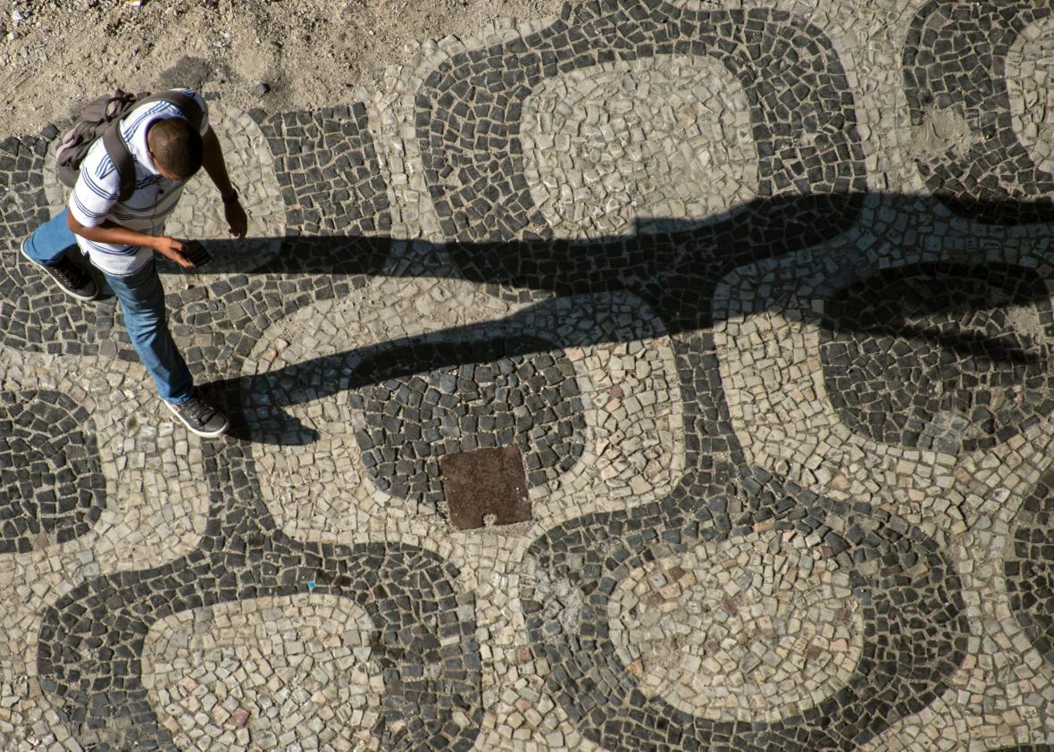 501779240-man-walks-with-his-mobile-phone-in-his-hand-in-downtown 501779240-man-walks-with-his-mobile-phone-in-his-hand-in-downtown
