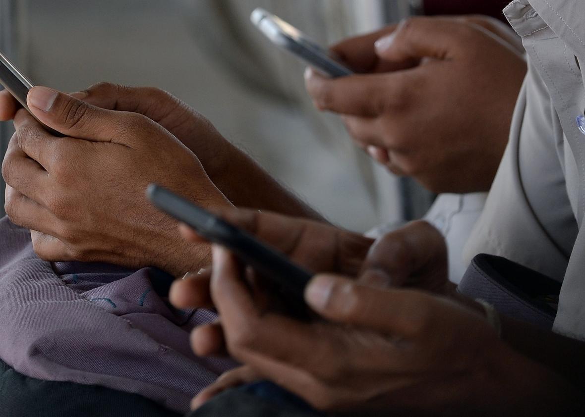 511826246-indian-consumers-check-their-mobile-telephones-at-a 511826246-indian-consumers-check-their-mobile-telephones-at-a