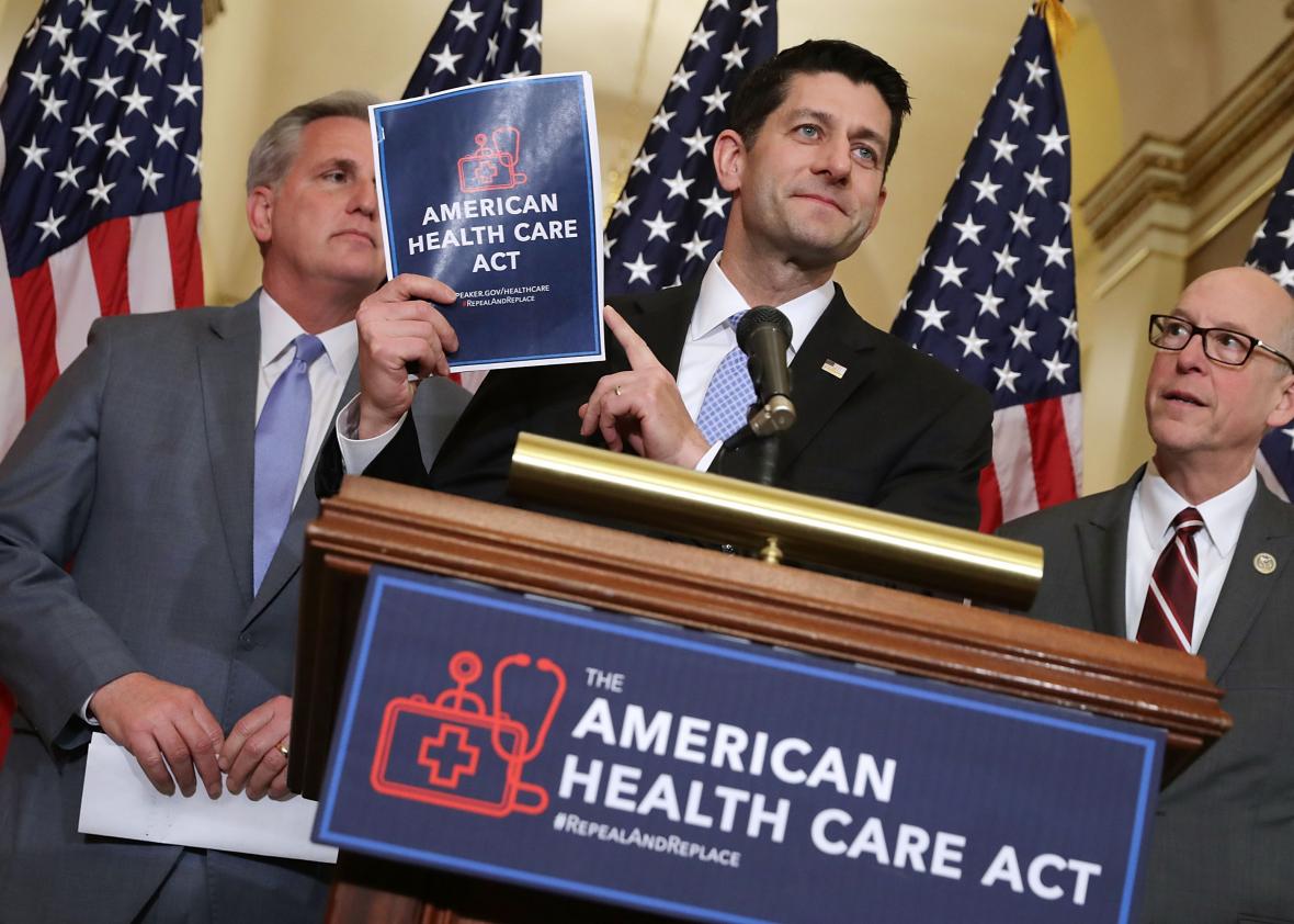 649341364-speaker-of-the-house-paul-ryan-holds-up-a-copy-of-the