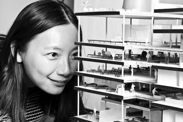 Liu looking through building model